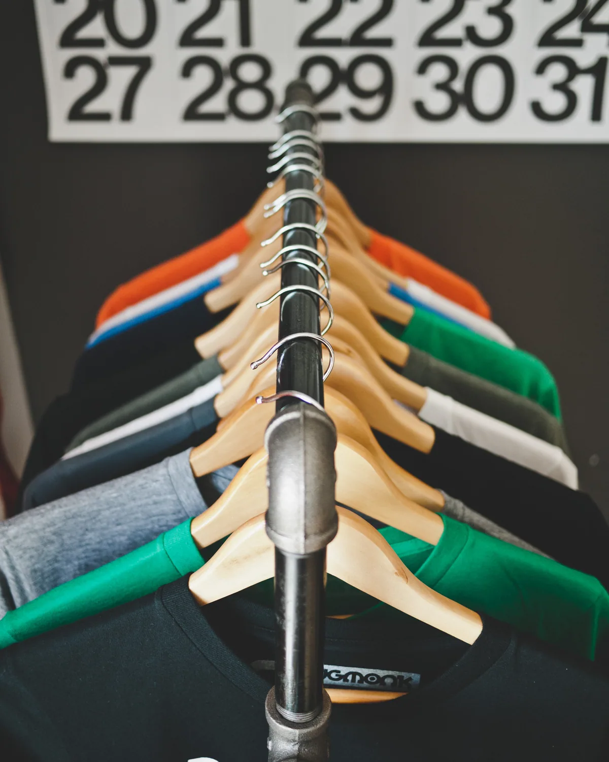 Colorful shirts on wooden hangers in a boutique